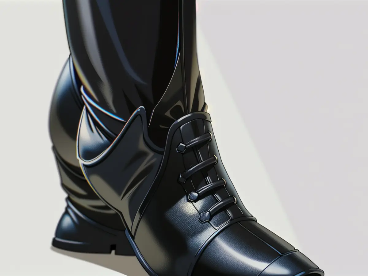 Pointed toe boots made from black faux leather