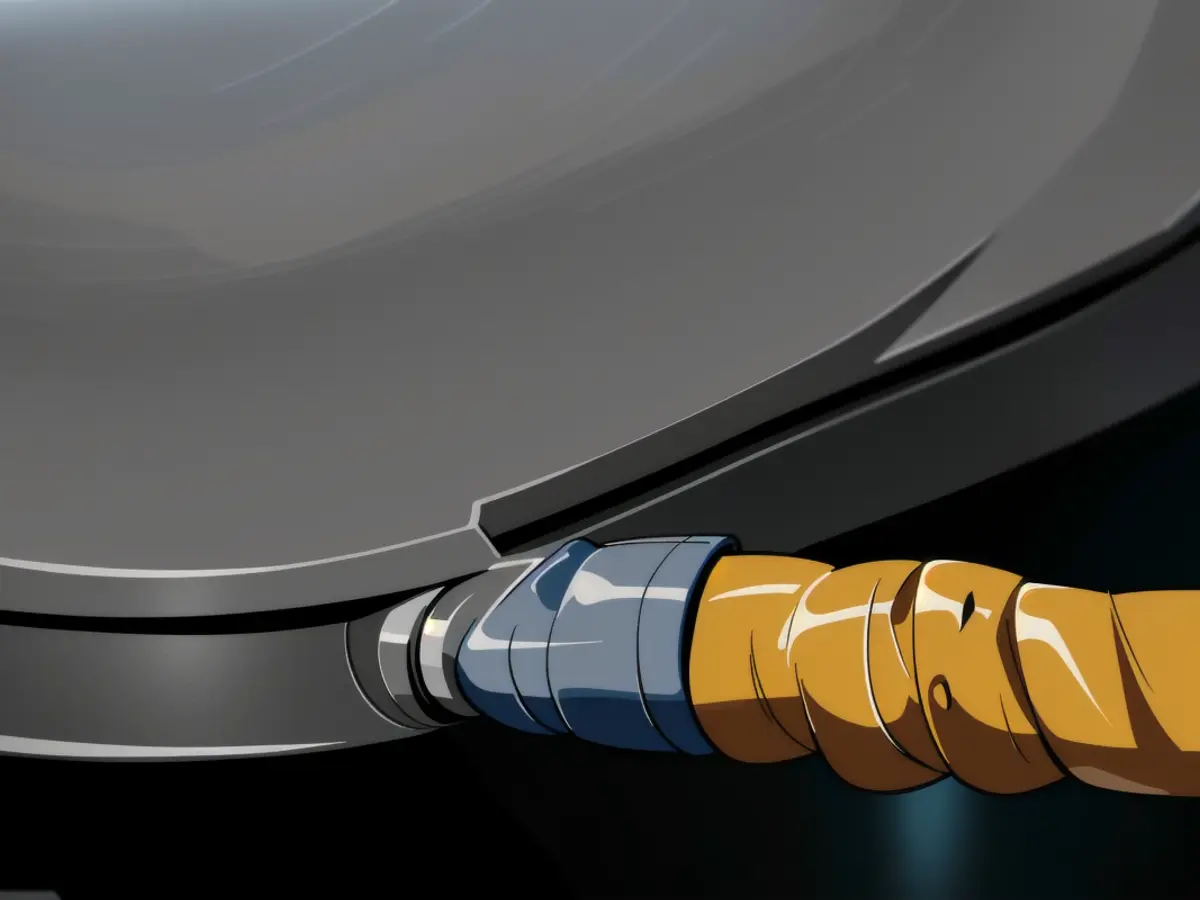 Focus on the shielding casing of a laptop cable connector. Focus on the shield-like object housing a laptop cable connection.