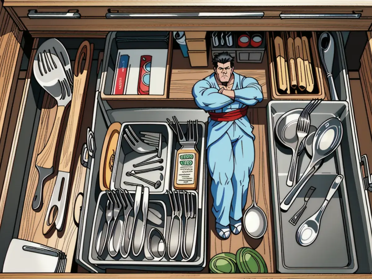 Drawer filled with assorted cooking tools and flatware, such as spatulas, forks, knives, and spoons, skillfully arranged in a drawer divider.