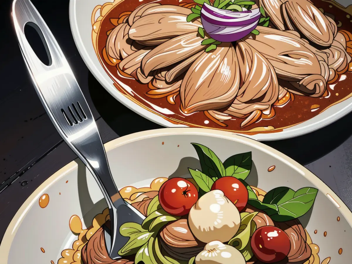 Chicken shredded in a skillet with a perforated spoon. Side dish consists of shredded lettuce, red onion, and tomatoes. Comment: 