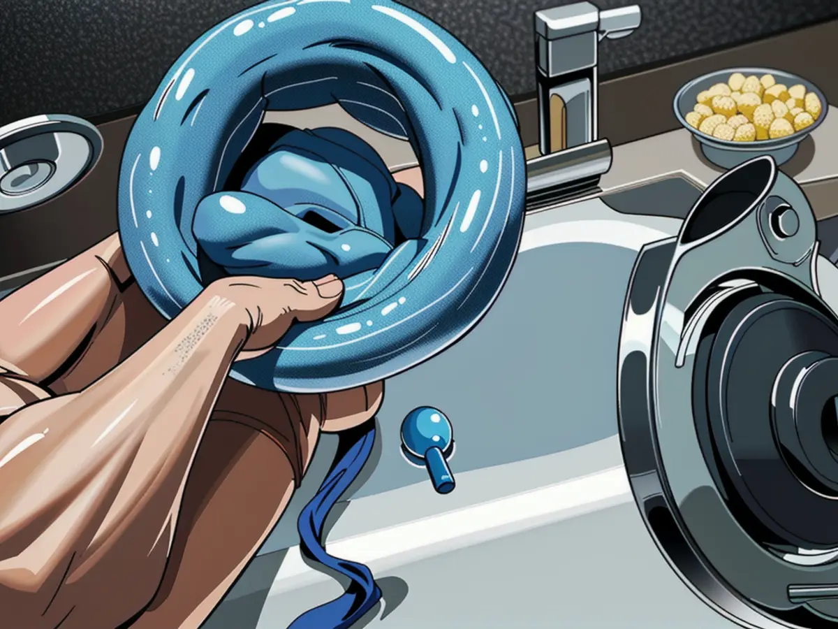 Evaluator wielding a blue Scrub Daddy above a basin Scrub Daddy reviewer scrutinizing blue sponge over wash basin.