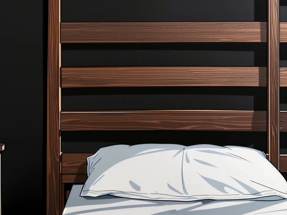 White Tempur-Pedic pillow on a white mattress, supported by a wooden bed frame. White Temper-Pedic cushion on a pristine mattress supported by a wooden bed frame