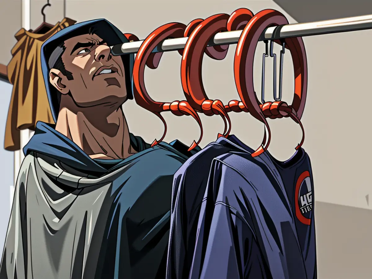 Five hoodies strategically placed inside a wardrobe, each adorned with a hoodie on its hanger. Closet contains five hooded garment holders, each adorned with a hoodie.