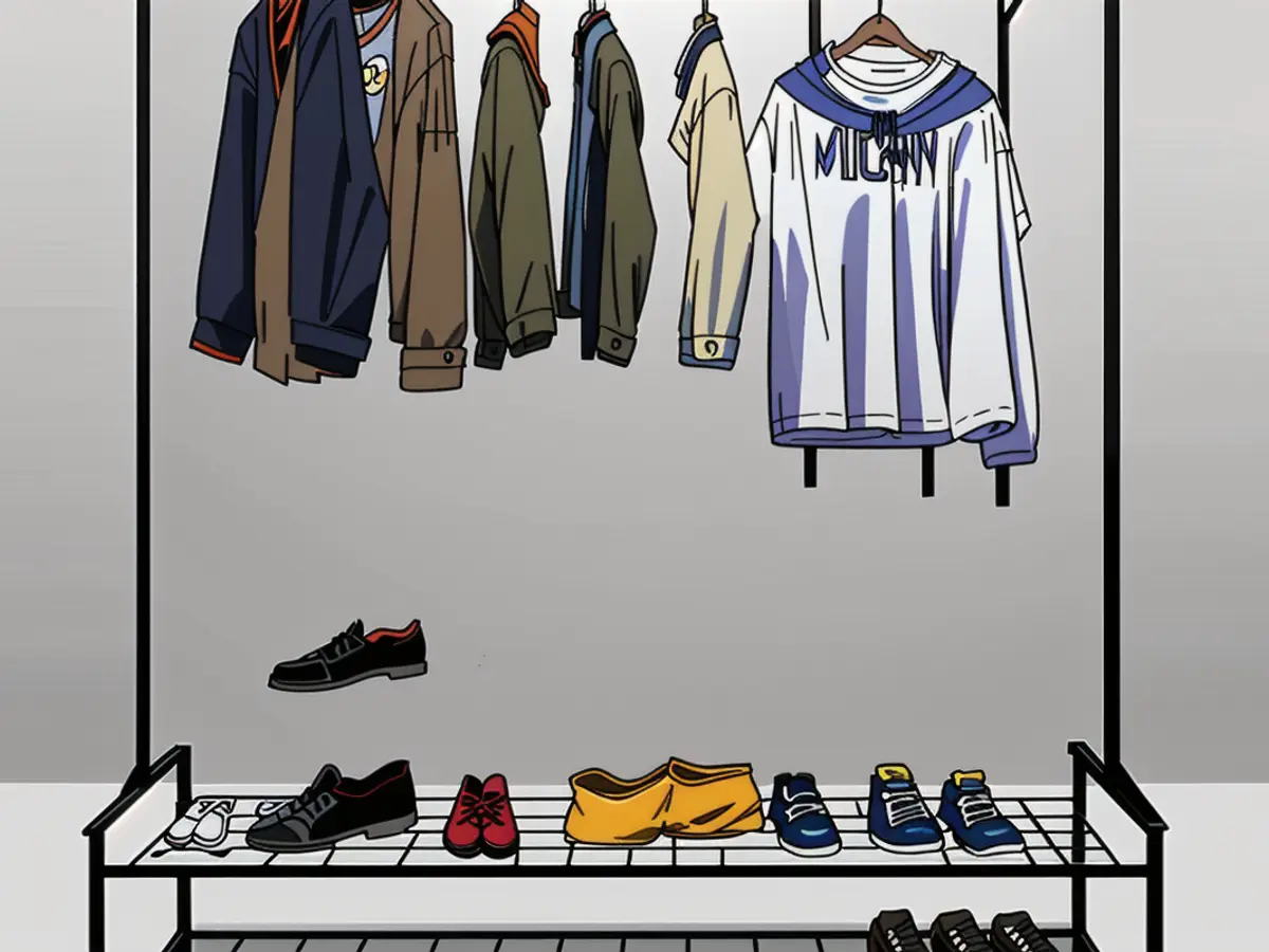 Standalone apparel rack, fully stocked with garments, featuring two lower shelves housing footwear and an upper shelf holding folded clothes and a bag. Standing wardrobe in black, adorned with clothes and two shelves. Lower shelf holds footwear, while the upper shelf houses folded garments and a bag.