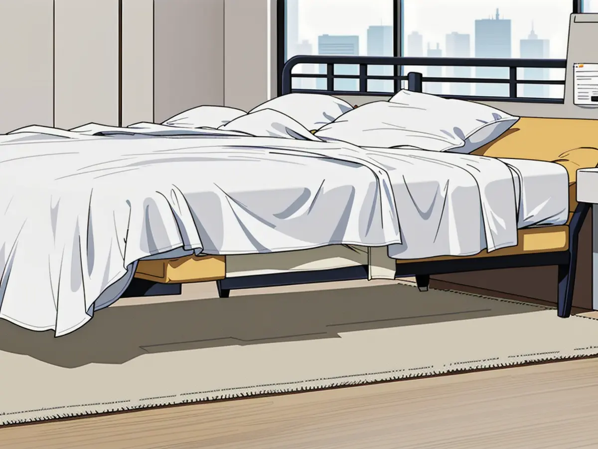 Binders made of transparent plastic are found beneath the white mattress Under the white bed, four transparent plastic binders have been positioned.