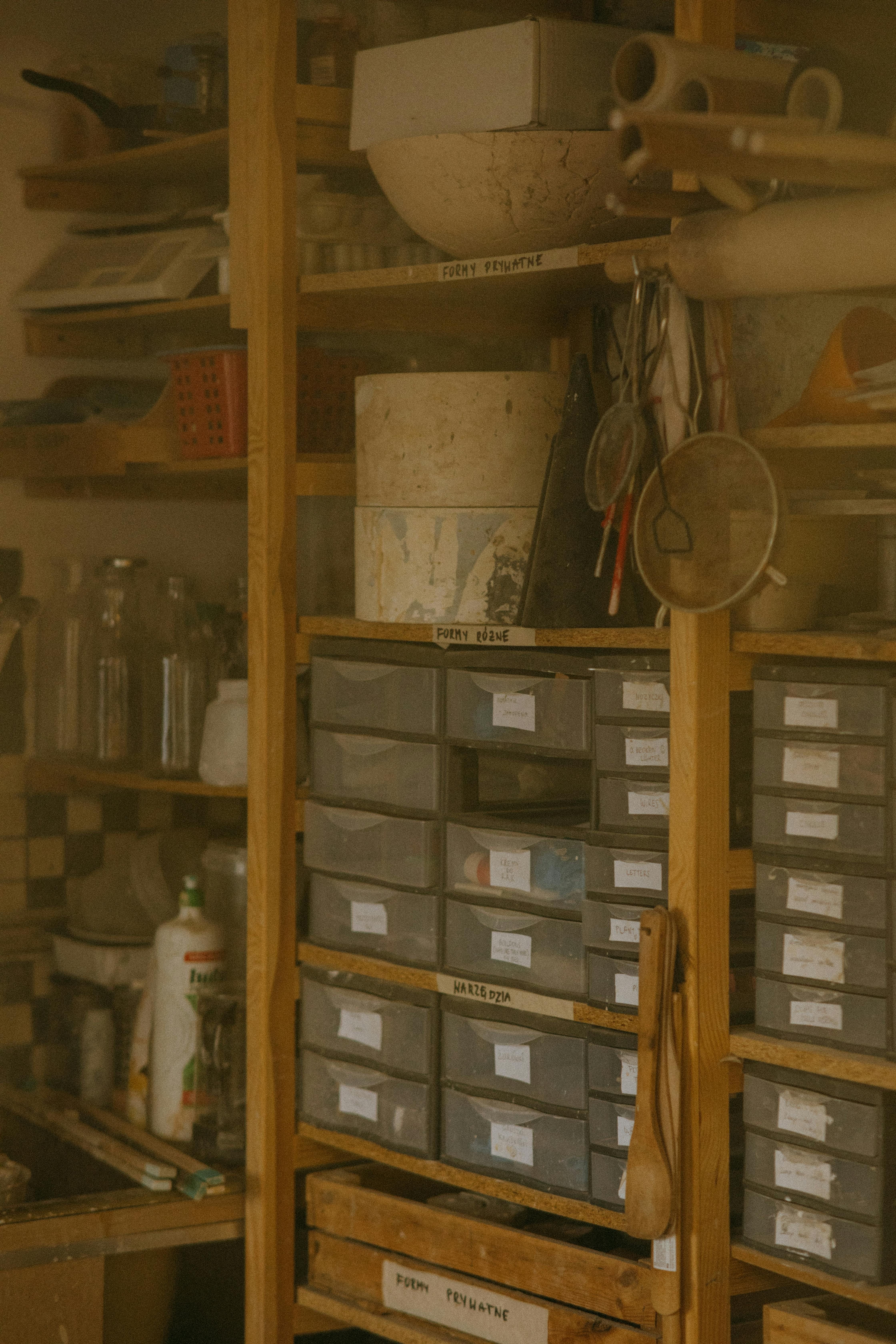 Multiple kitchen item containers stacked on a storage box organizer Multi-compartment kitchen organizer, adorned with assorted kitchen item containers.