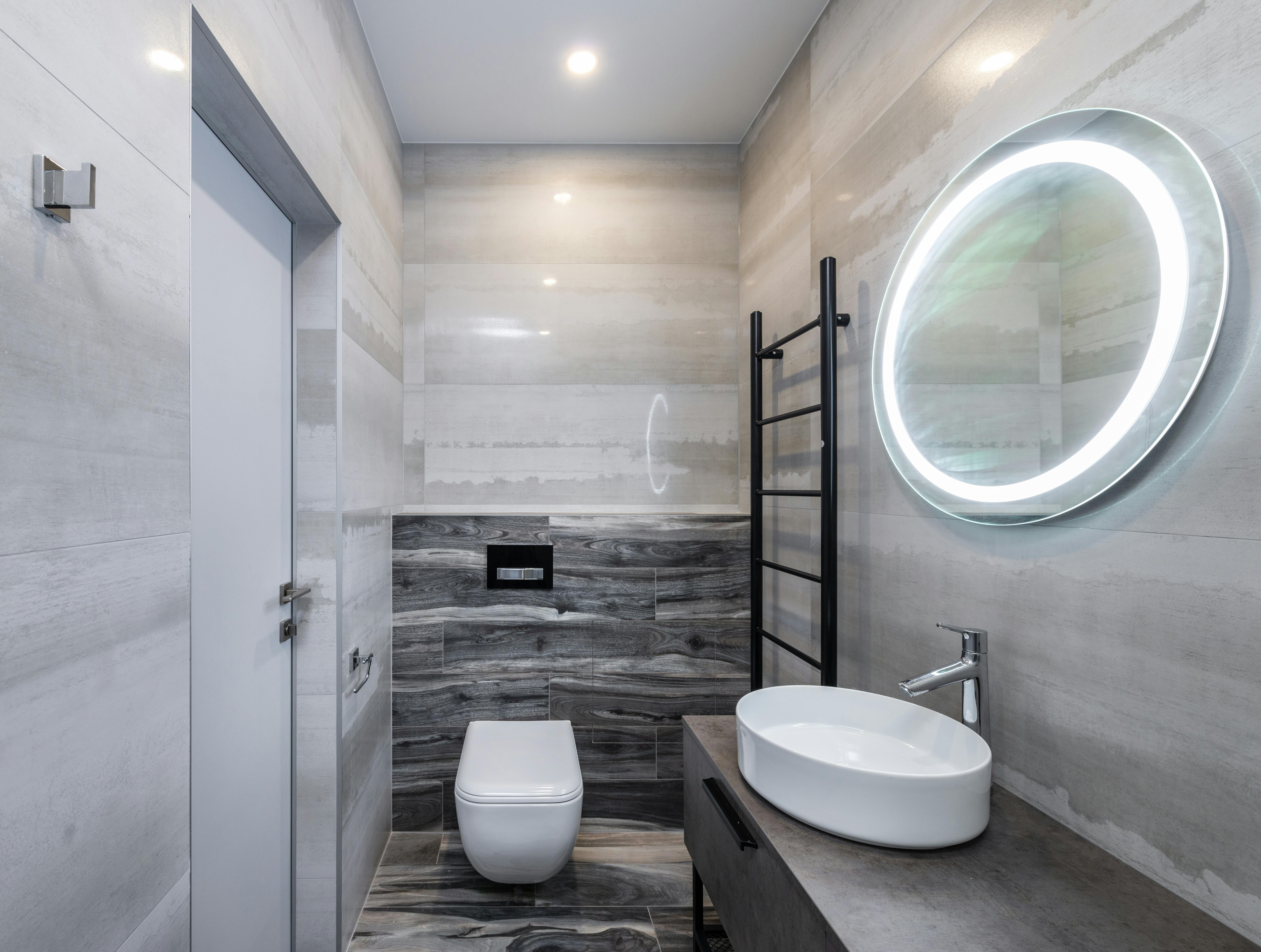 Wall-mounted reflective surface equipped with hanging fixtures.