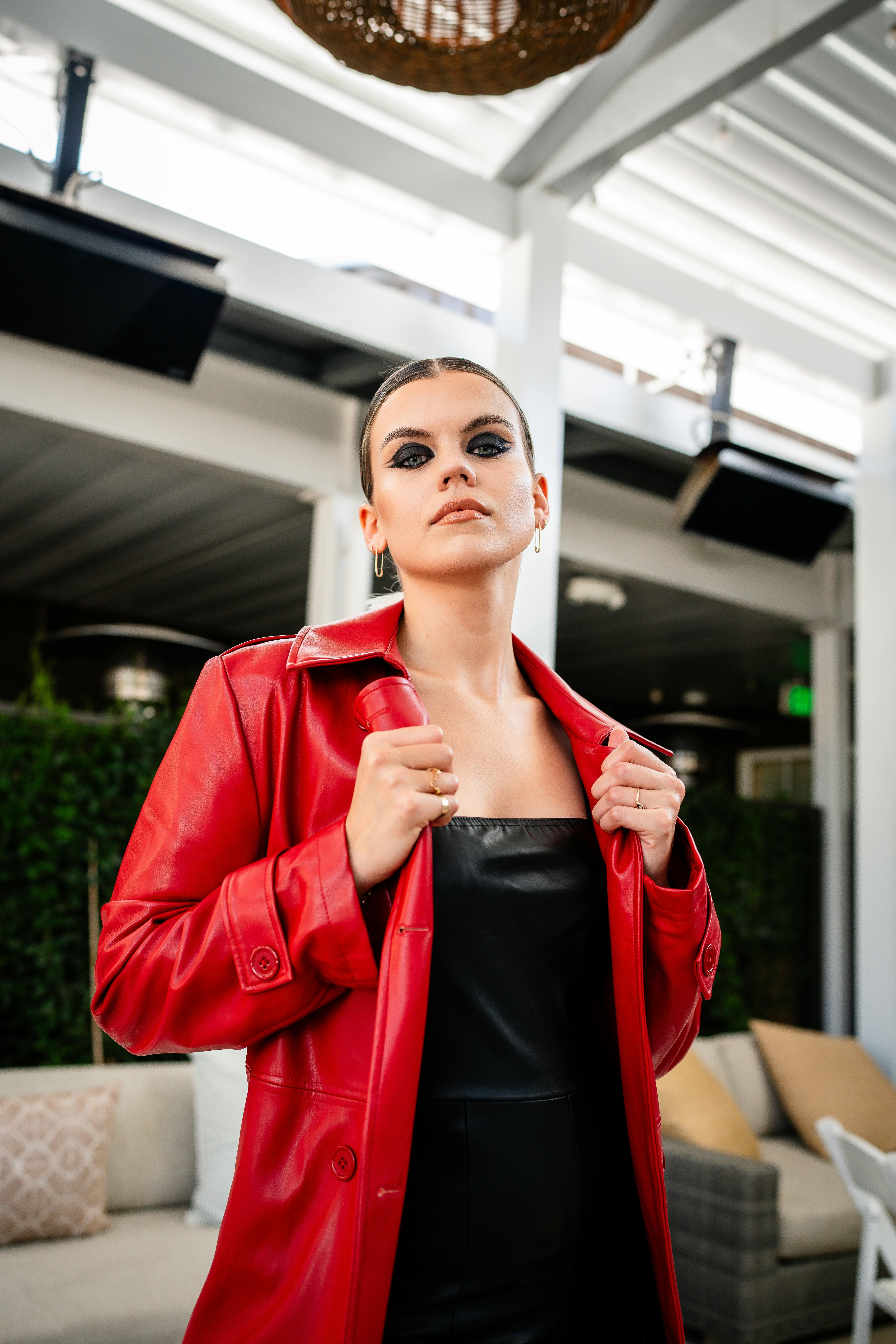 Individual sporting a dark outerwear garment. Individual donning a black coat in focus