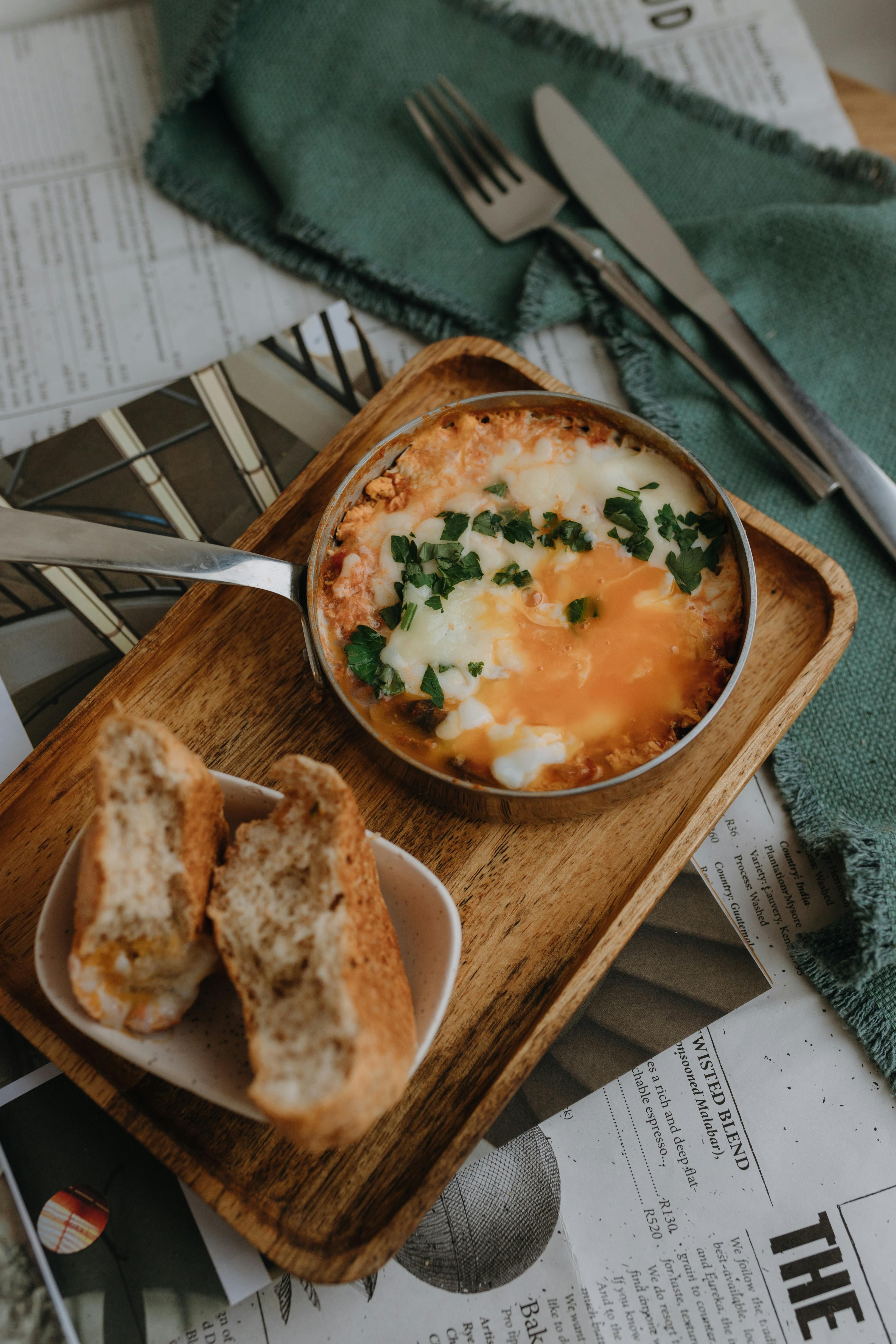 Sautéed kale and cheddar mixture with baked eggs in a skillet Pan-fried kale and cheddar mixture topped with baked eggs