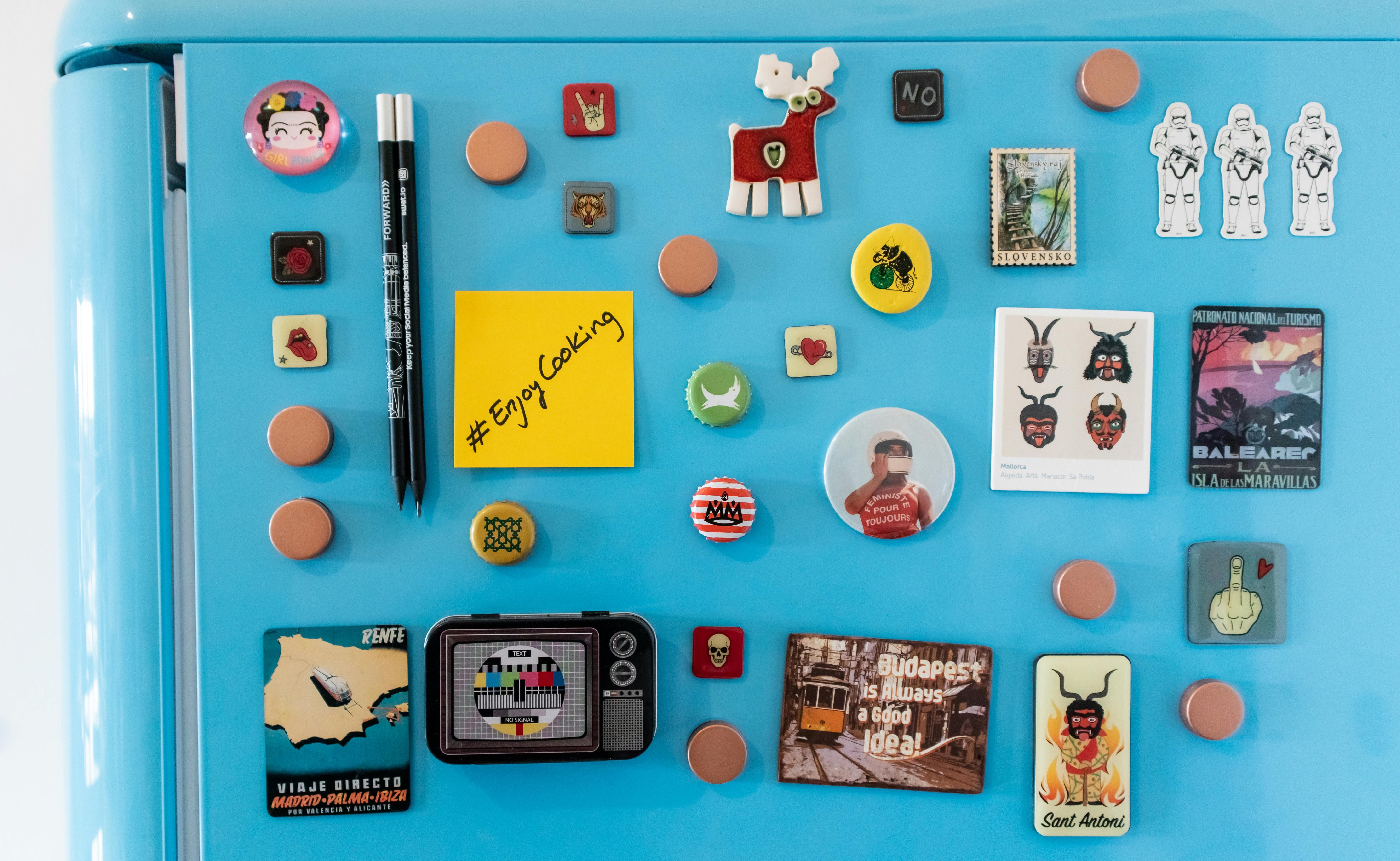 Magnets affixed to the refrigerator for storage purposes Adhesive-backed magnetic organizer for refrigerator door