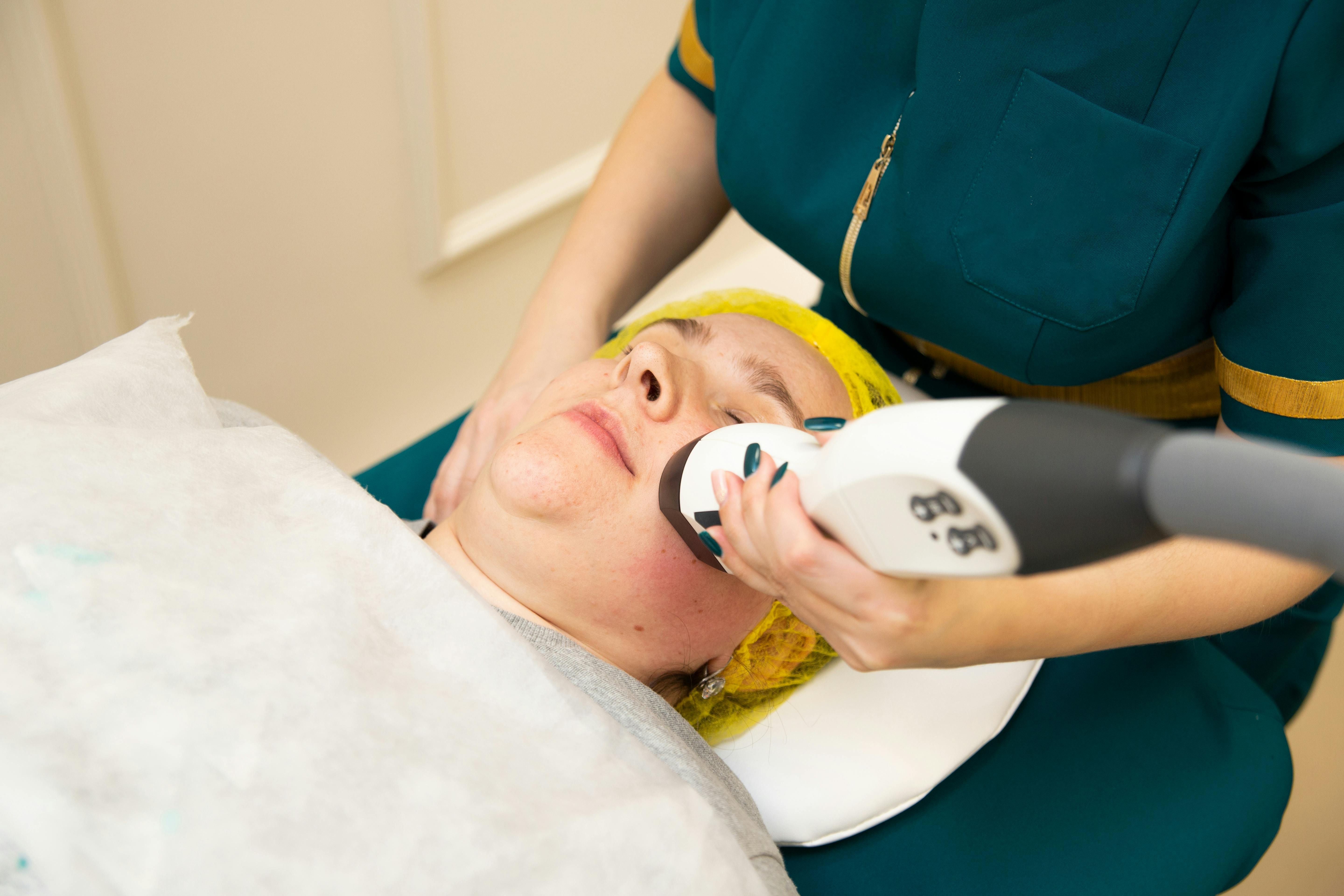 Cat undergoing facial massage with a tongue-like device equipped with massage balls.