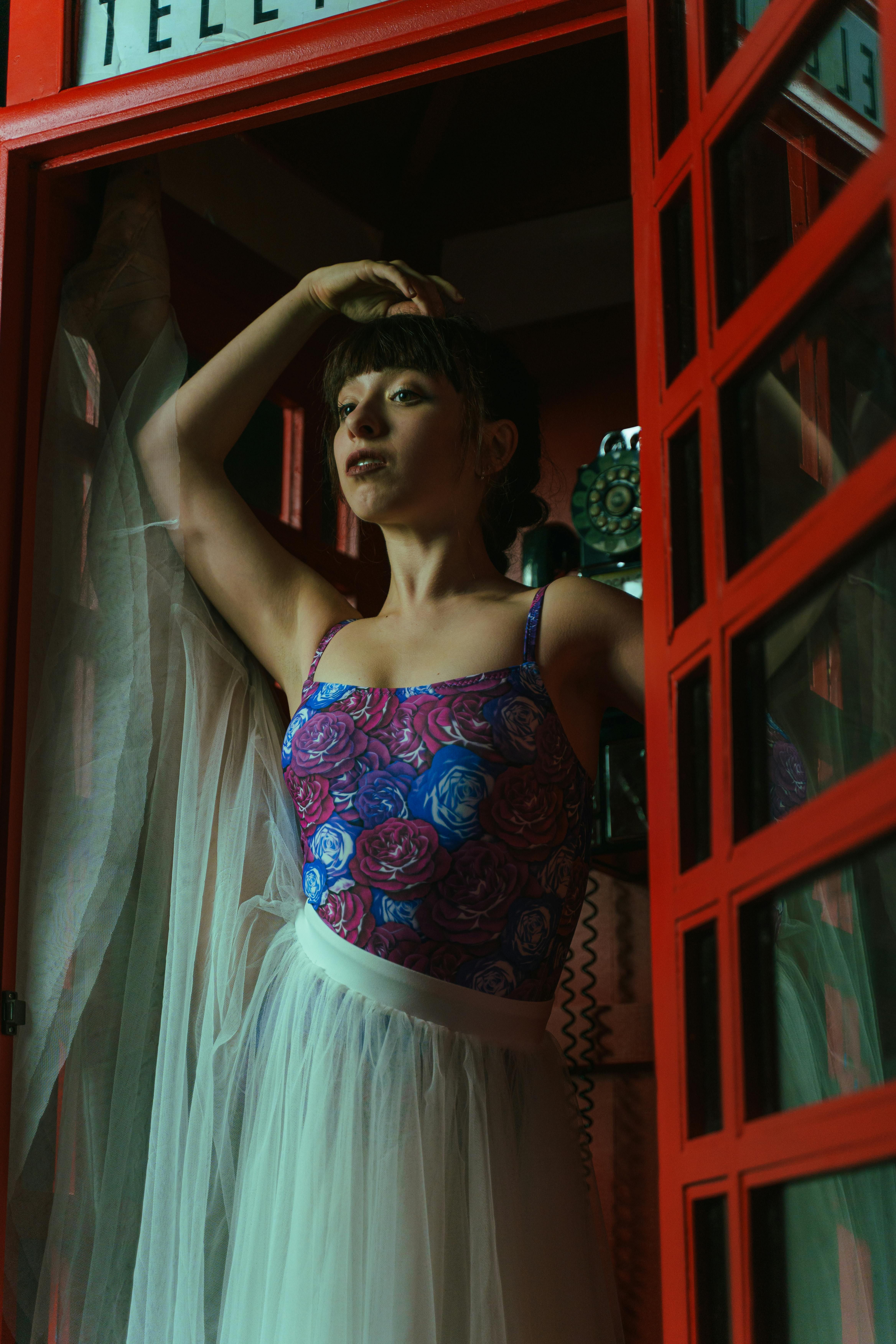 Female model donning a maxi dress in cobalt blue, featuring spaghetti straps. Woman in cobalt-blue maxi dress with spaghetti-style straps.