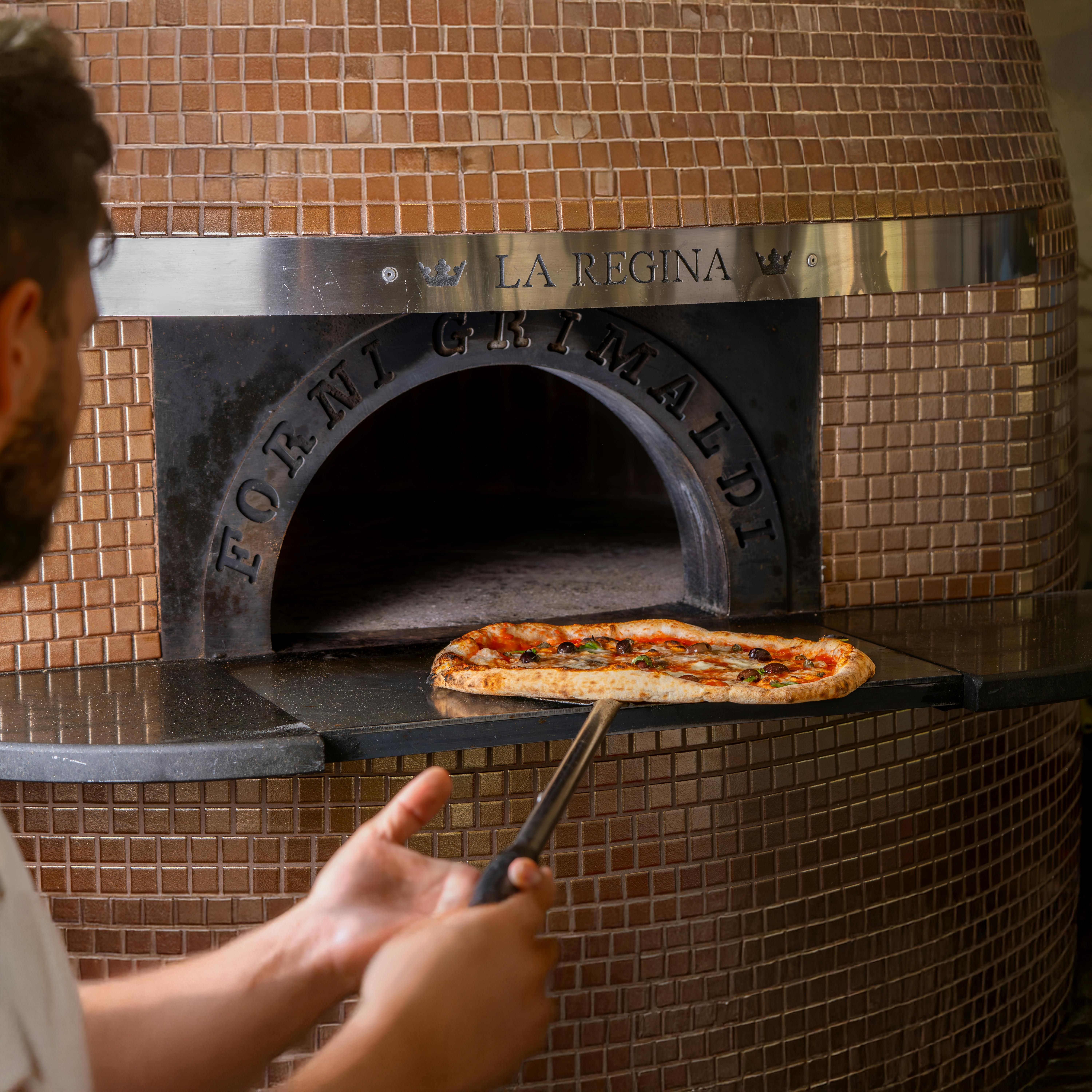 Oven-baked pizza residing on the heated stone slab