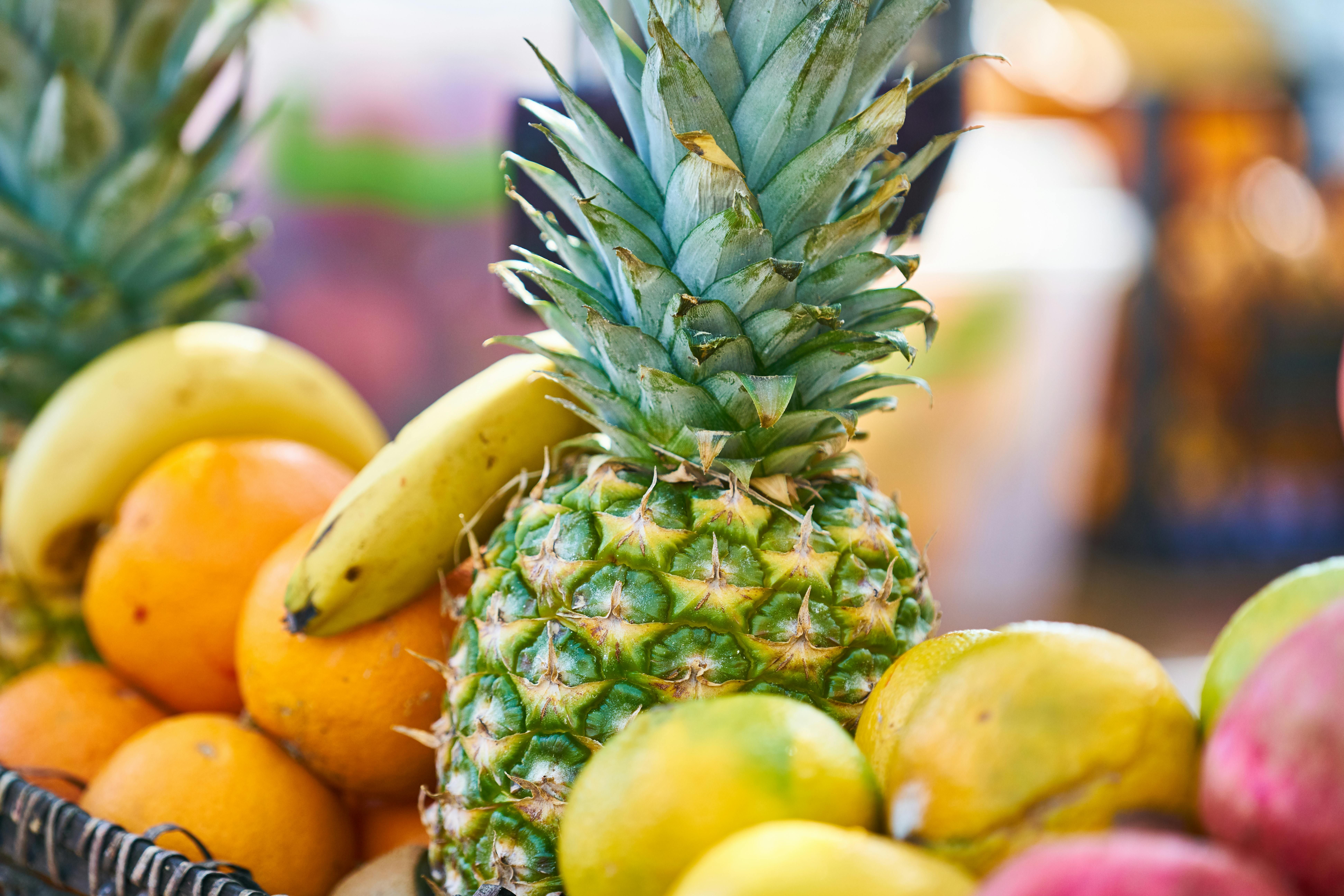 Image showcasing a two-tiered basket filled with an assortment of fruits and vegetables. Snap of a Double-Tiered Fruit and Vegetable Basket, Showcasing a Variety of Produce Within