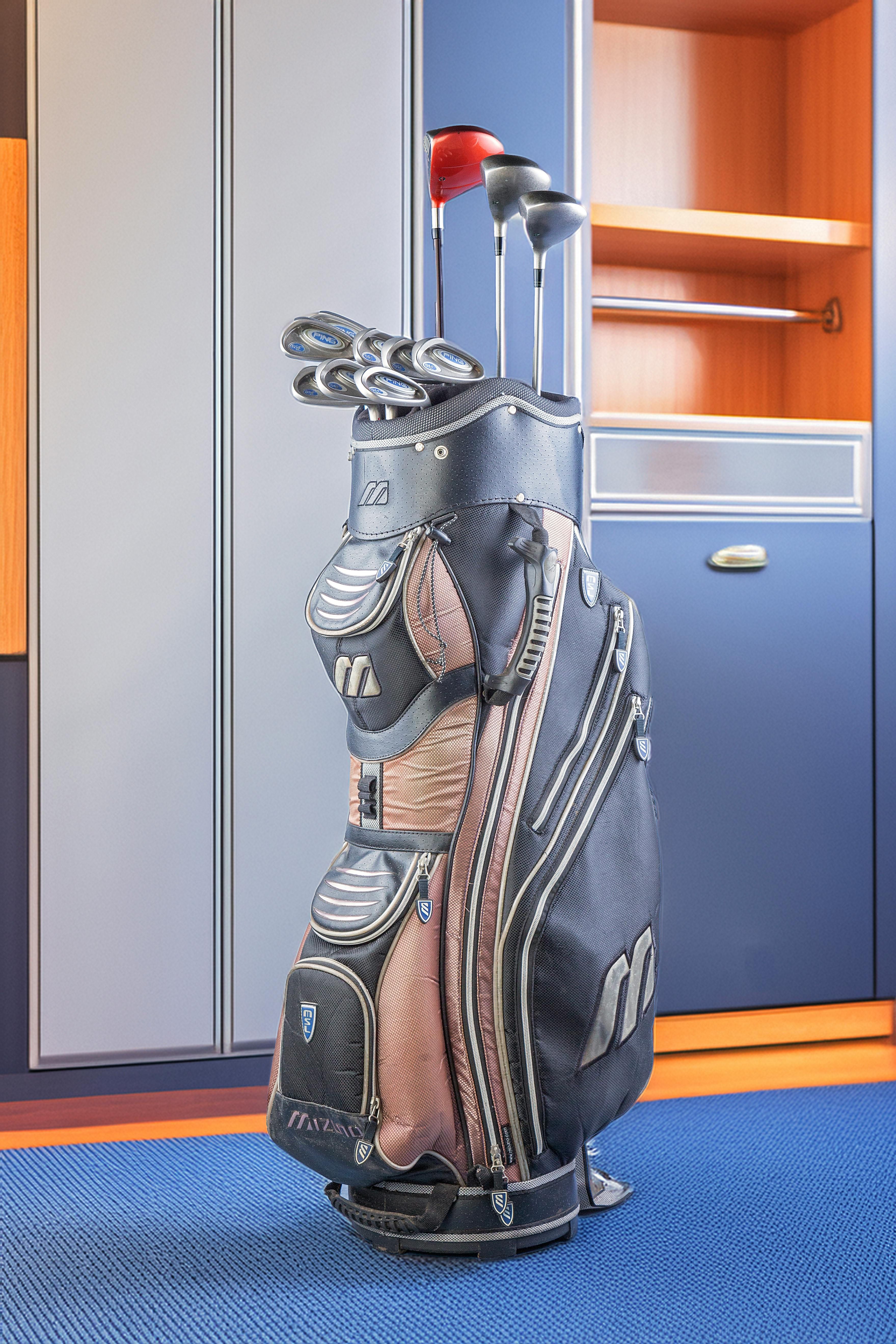 Assorted golf gear contained within a storage set for golf enthusiasts. Collection of assorted golf goods enclosed within a storage set