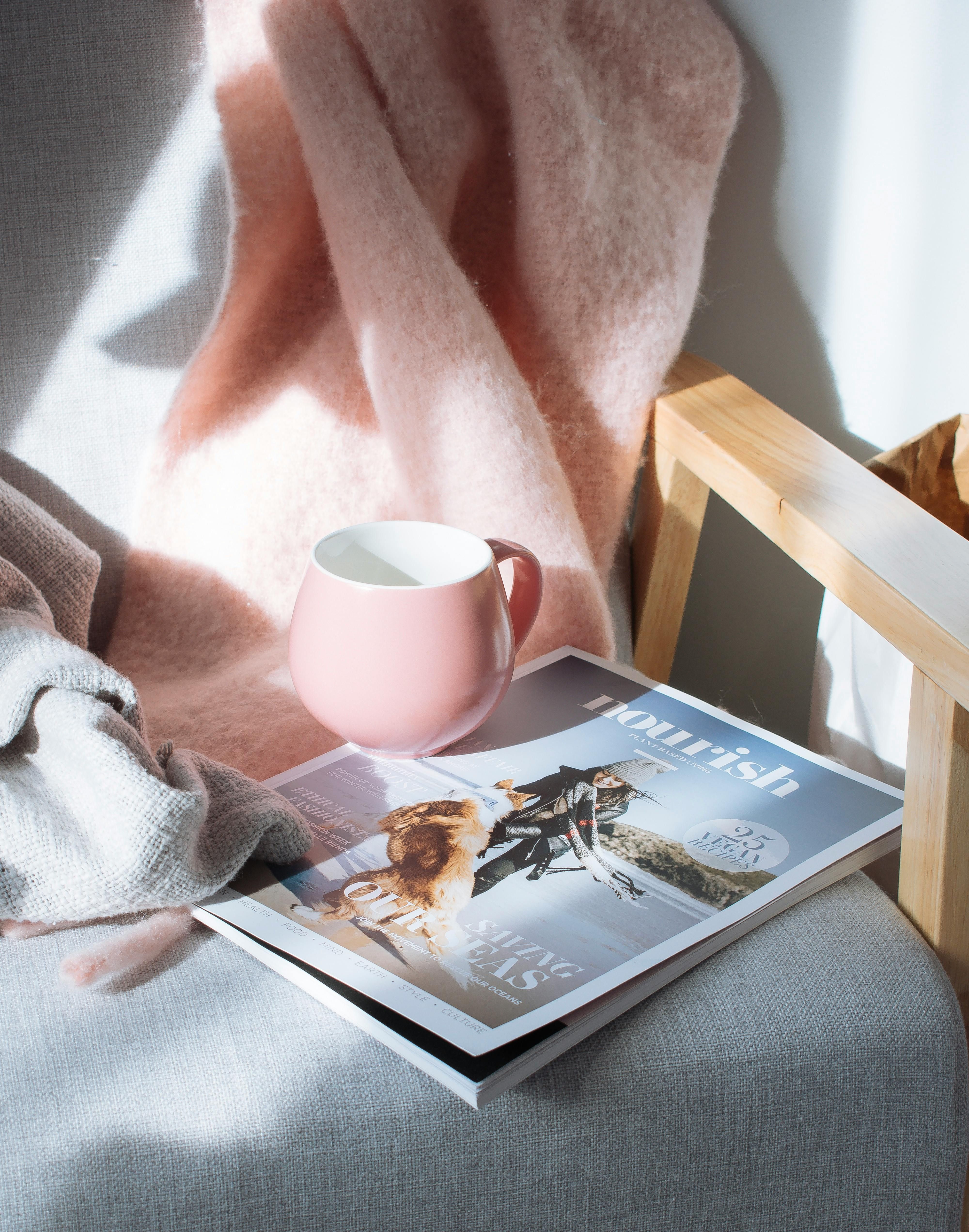 Coffee steaming in a mug on a pink heating device Coffee steaming in a mug, warmed on a pink heating pad