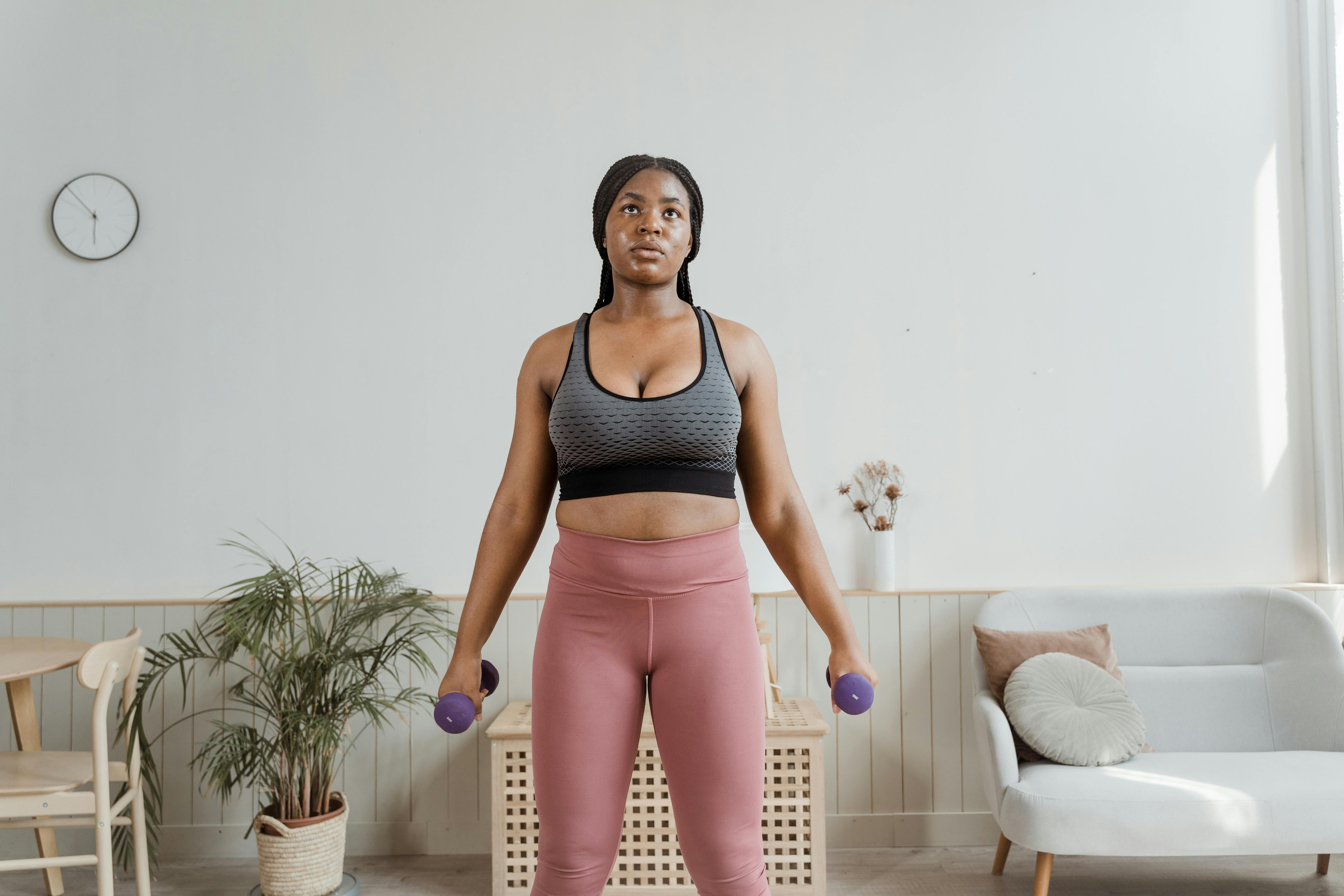 Weight Lifting Session Captured: Reviewer Dons Identical Hue Sports Bra and Leggings in a Hot Pink Shade Weightlifting enthusiast sports matching pink attire: a pink sports bra and pink leggings.
