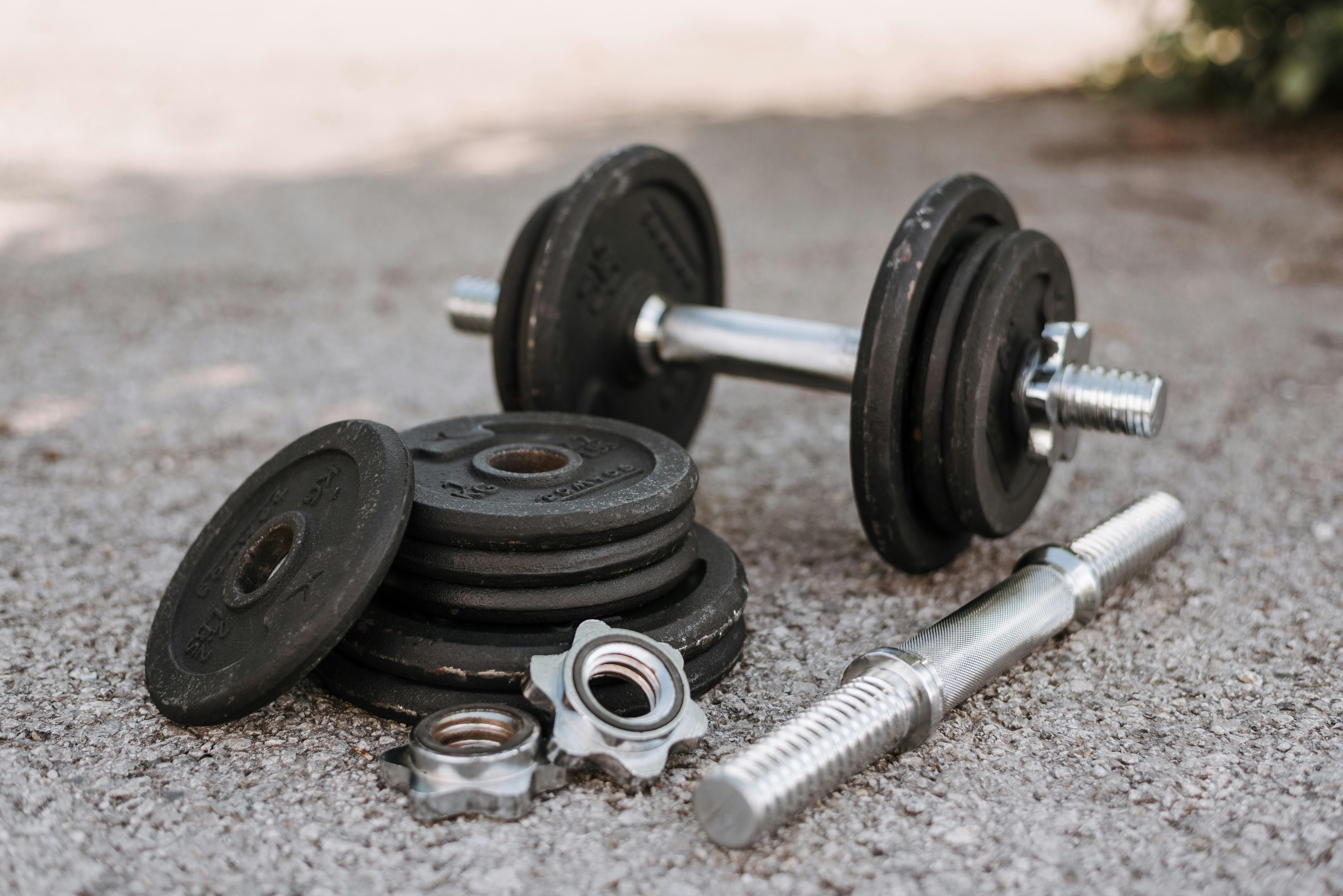 User grips a versatile black dumbbell in their grasp User weighs a versatile, adaptable weight in their grip