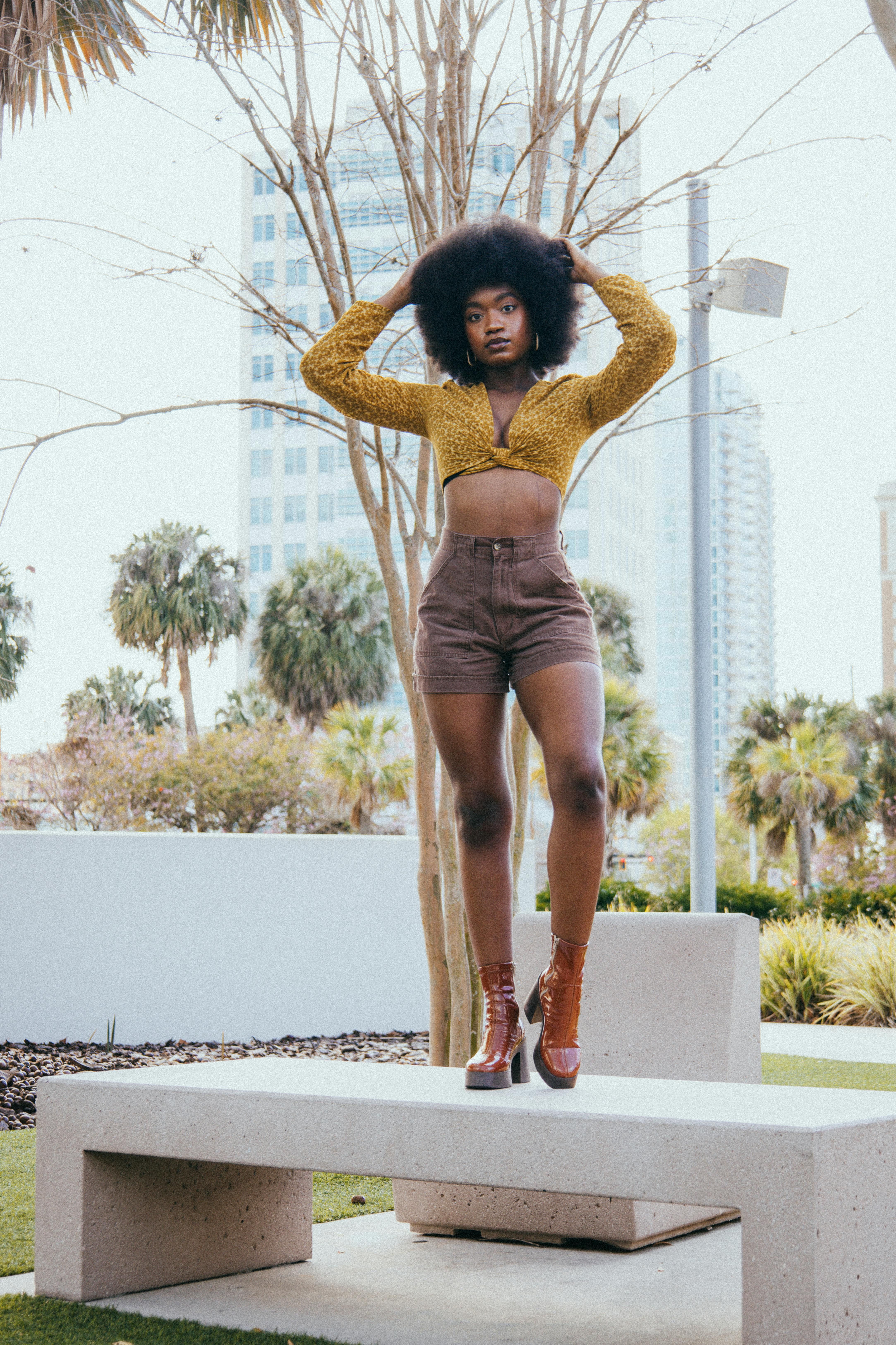 Model dons high-waisted leggings with contrasting black and white prints. User dons bold black-and-white striped high-waist leggings.