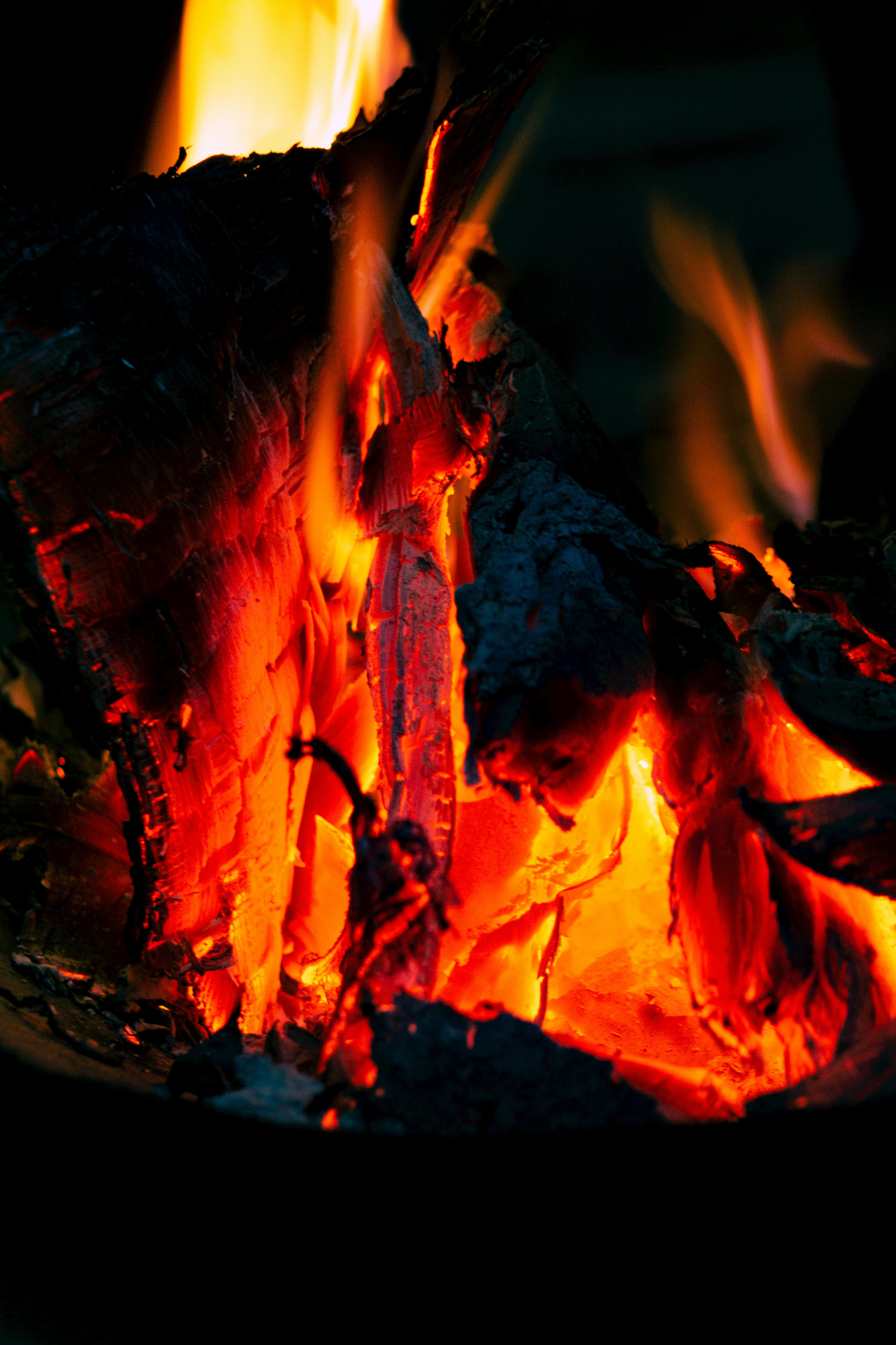 Image portrayal of vibrant, dancing flames within a fire pit Vibrant, blazing snapshots depicting a fire pit ablaze with flames