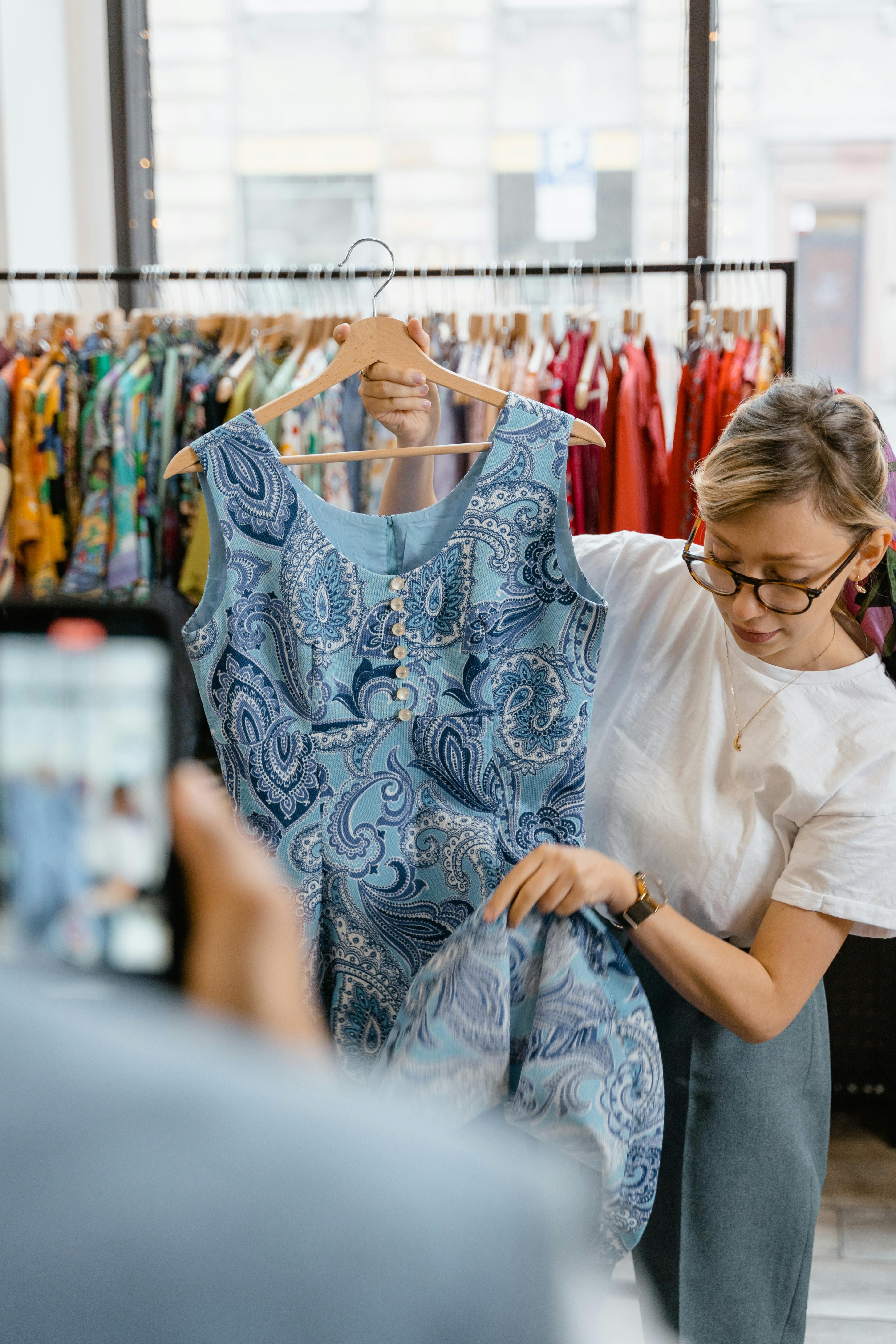 Picture showcasing a customer donning the blue dress while posing in the review Photo showing a customer wearing the blue dress, as per their review