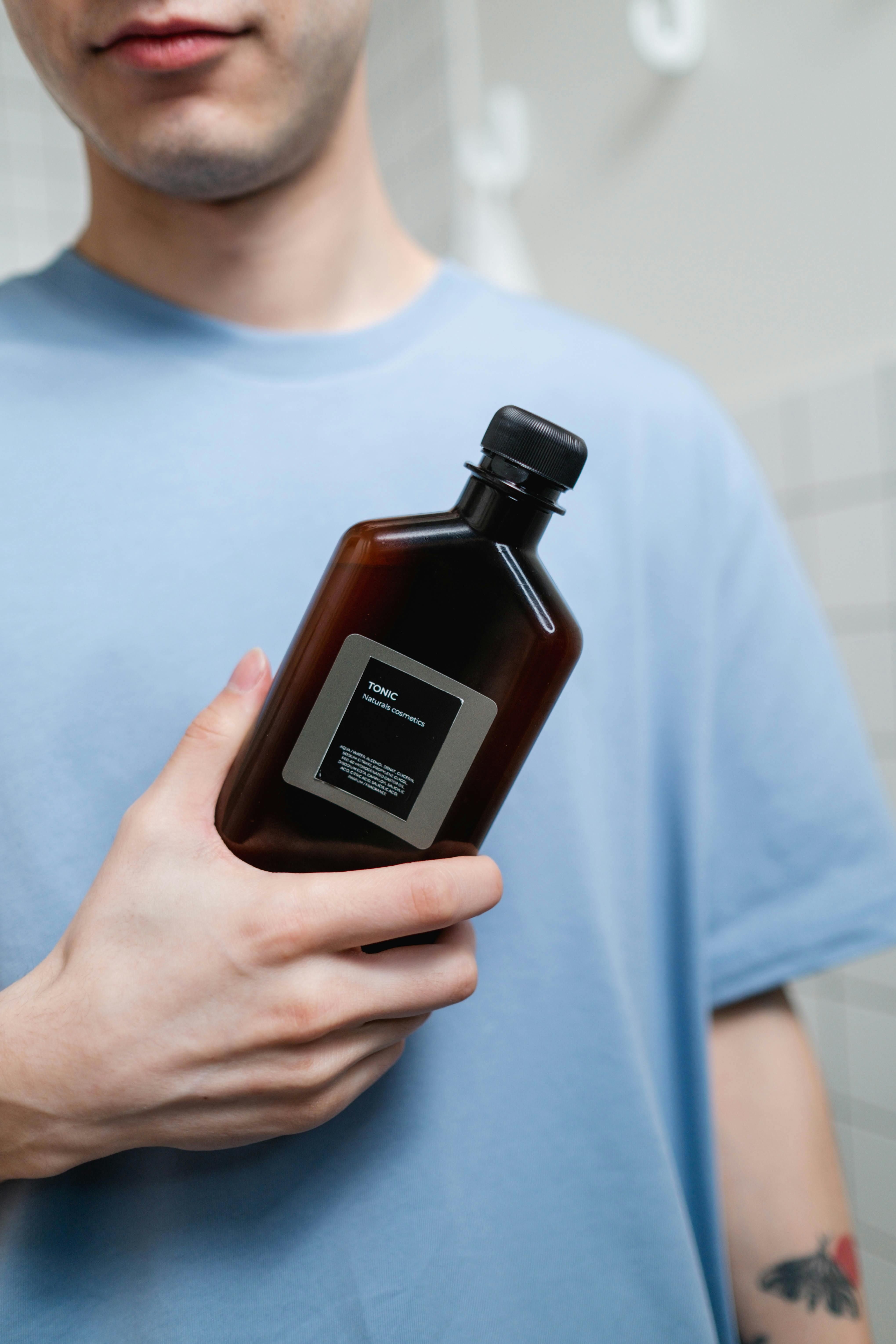 Bottle of blue toner cartridge Refilled ink tank of cyan hue