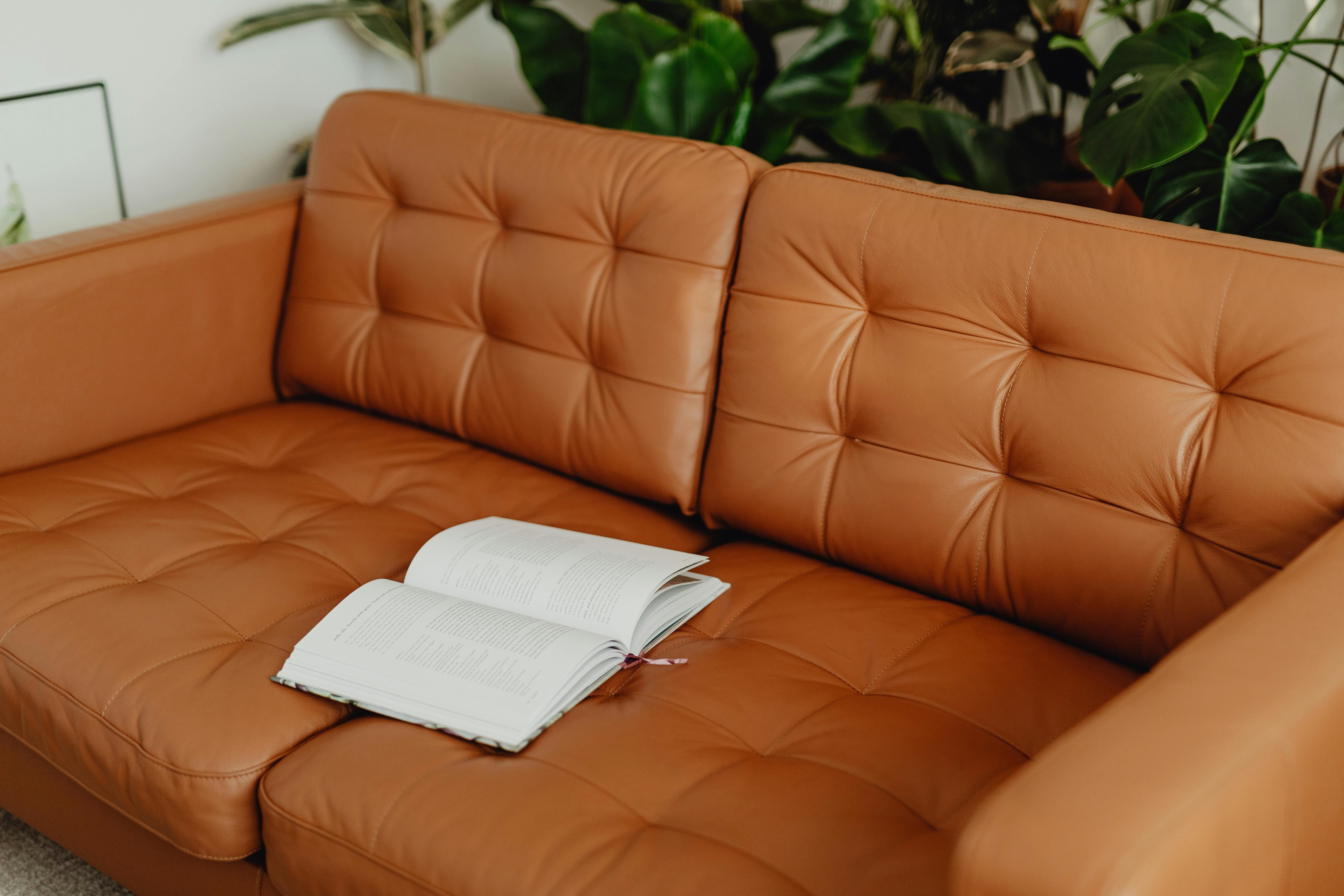 A synthetic leather-upholstered futon couch A synthetic-leather lounge couch, styled like a Japanese sofa bed.