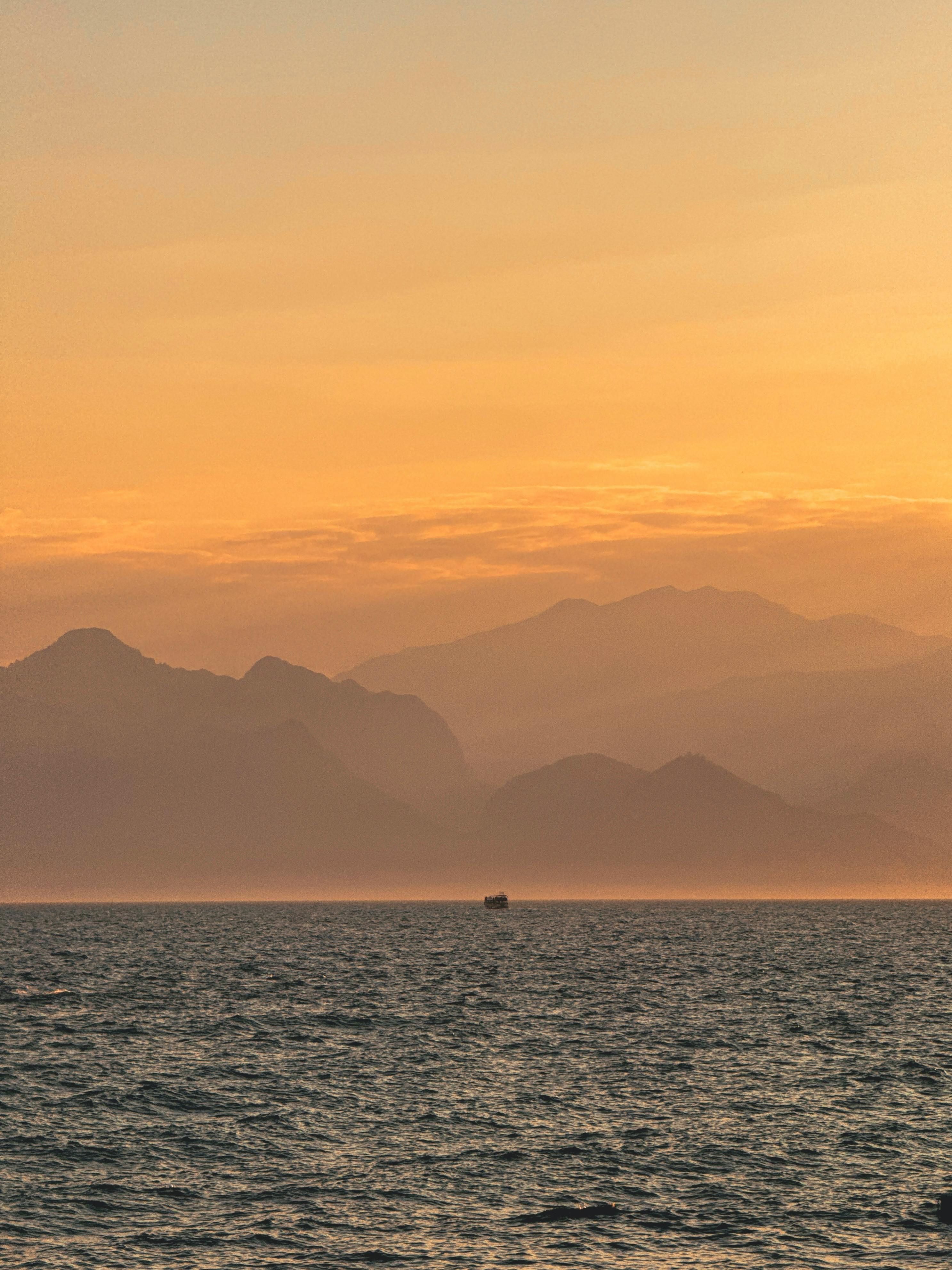 Drizzling heavily or gently showering with rainfall.
