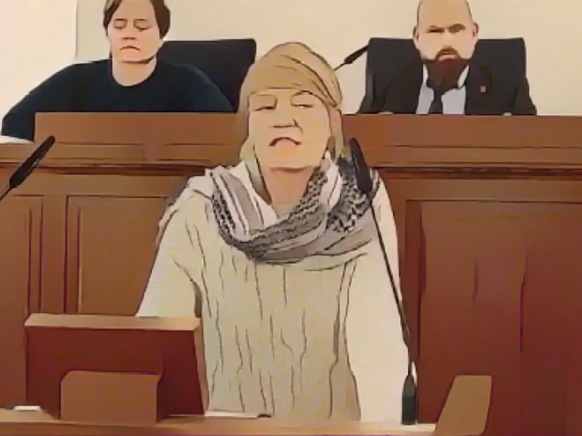 Left with Palestinian scarf at the lectern