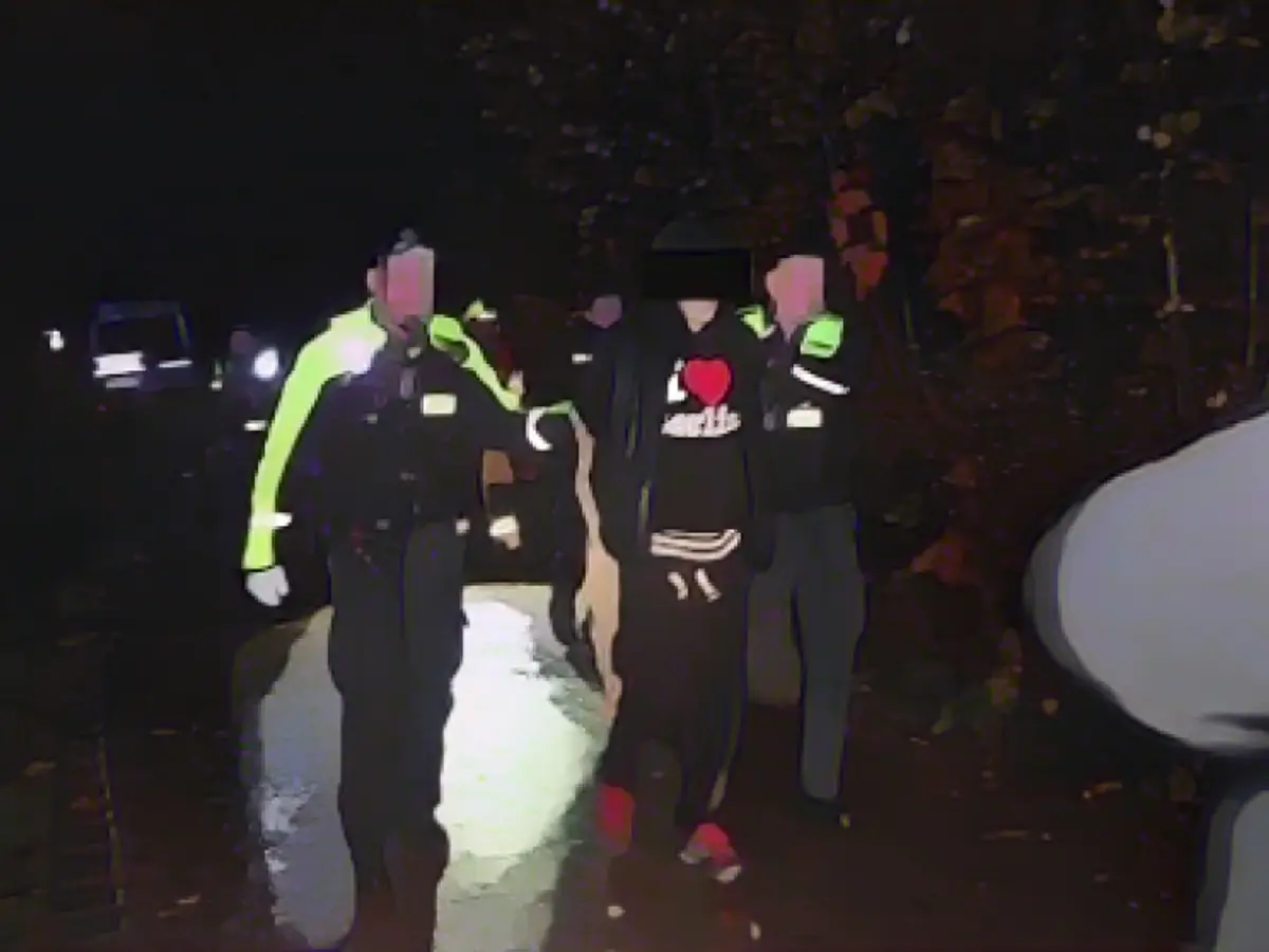 Suspect in heart hoodie taken away