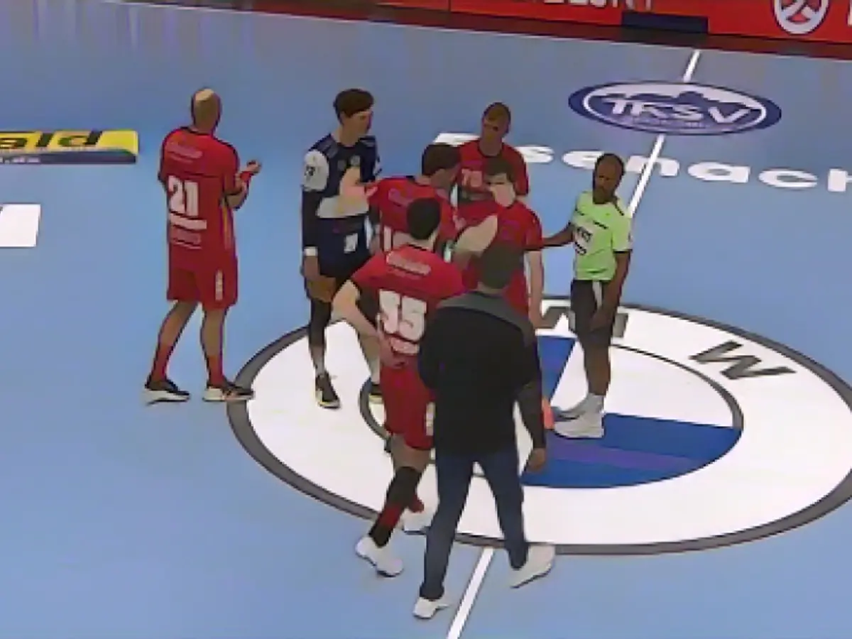 Suddenly the referee interrupts the game!