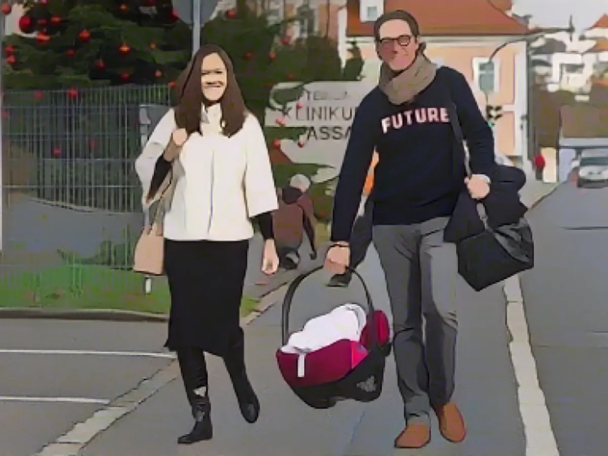 Here the former transport minister carries his baby home