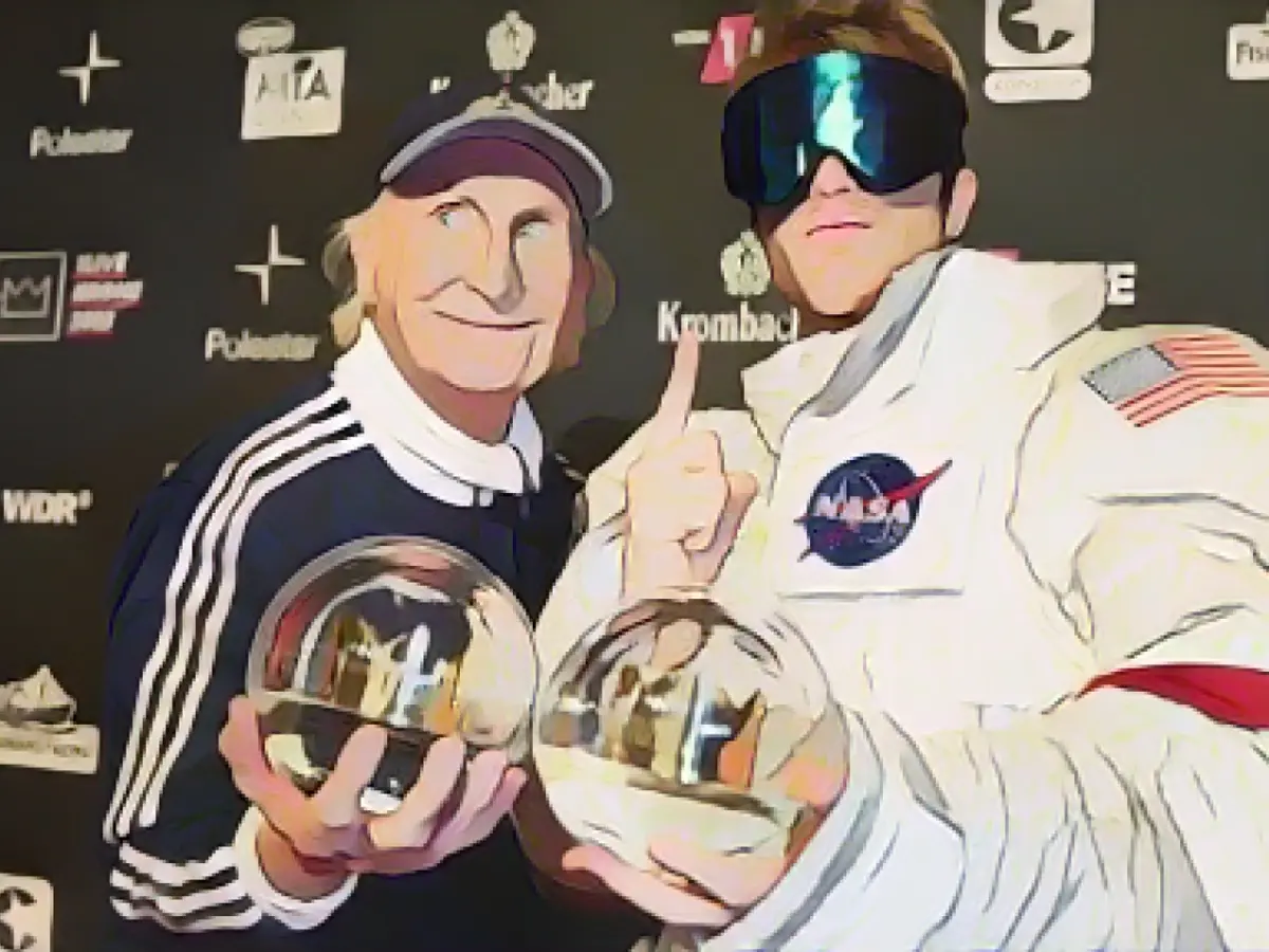 He beams alongside his young colleagues