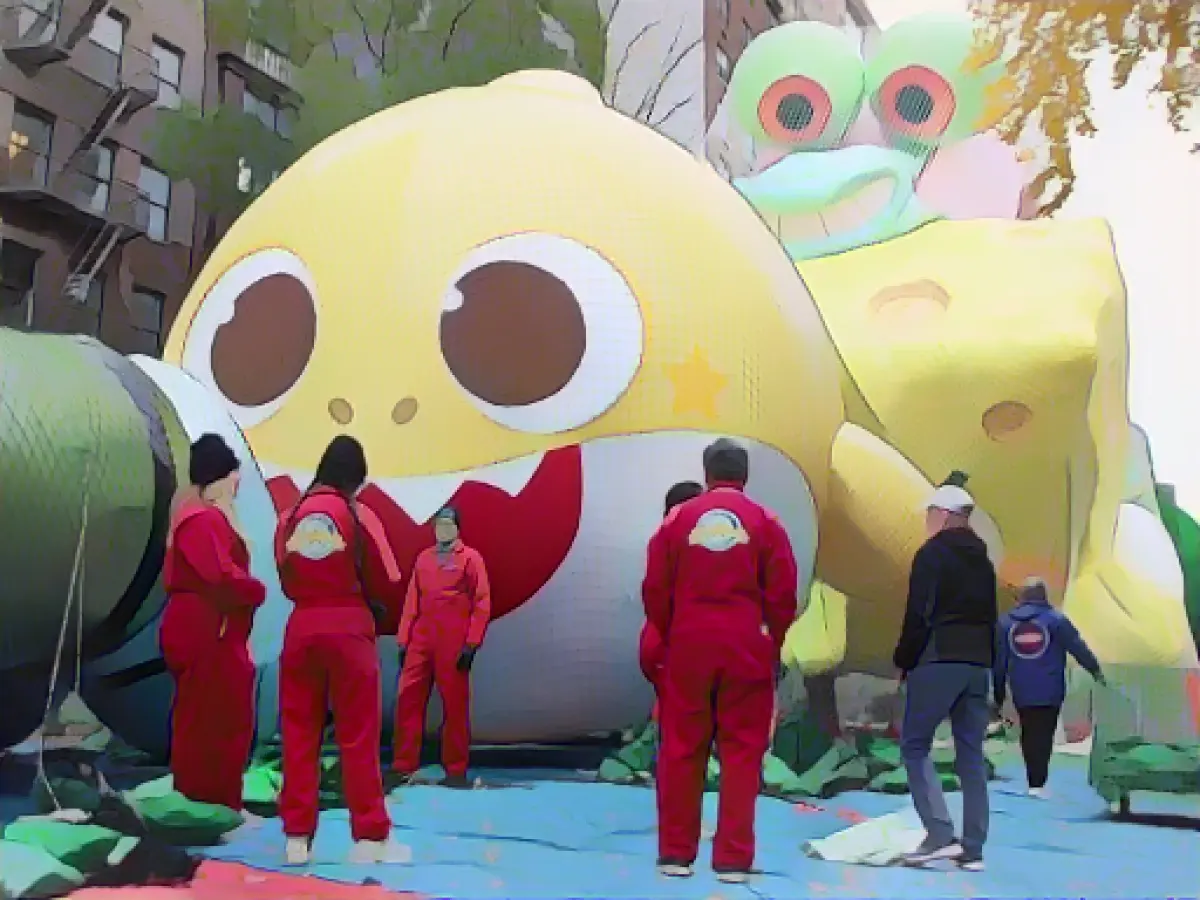 Thousands marvel at the inflation of Thanksgiving balloons