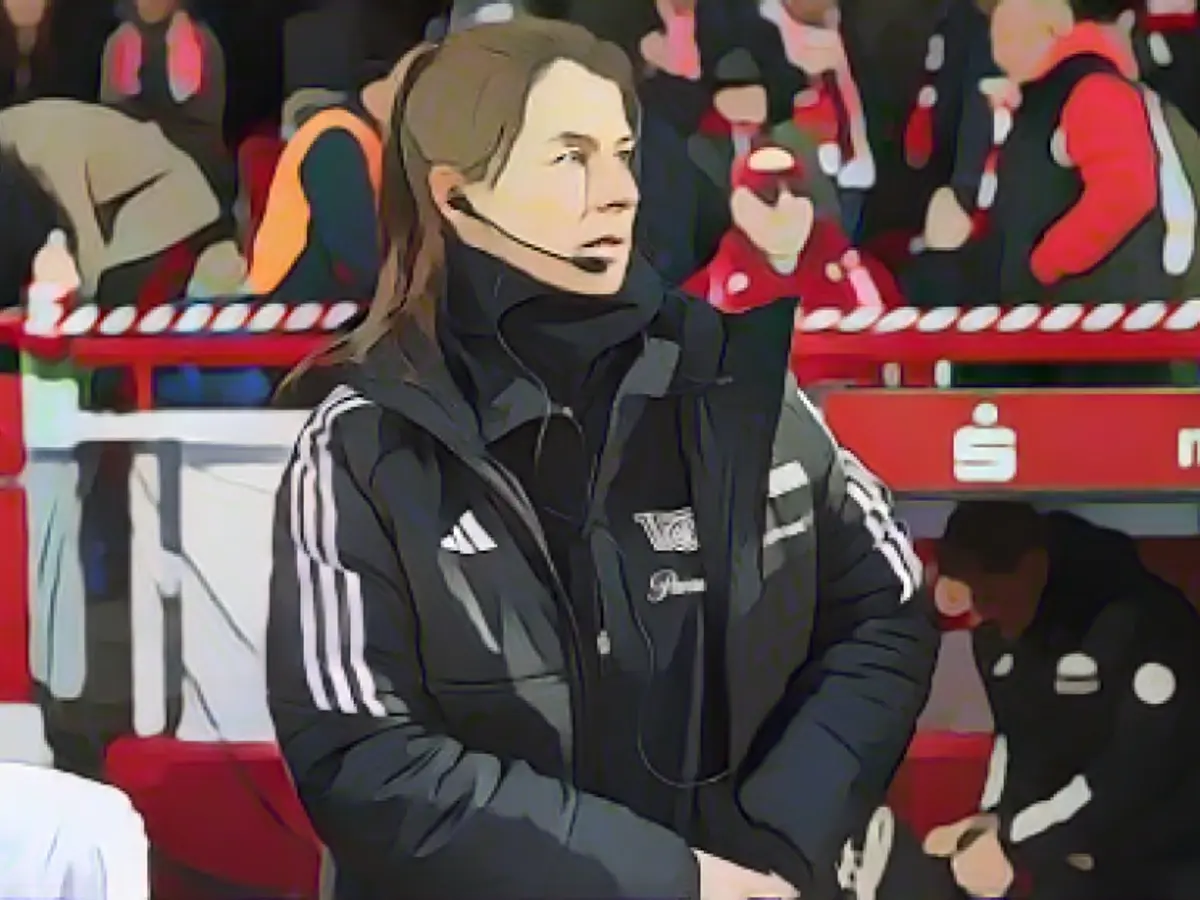 Union's assistant coach with headset on the bench