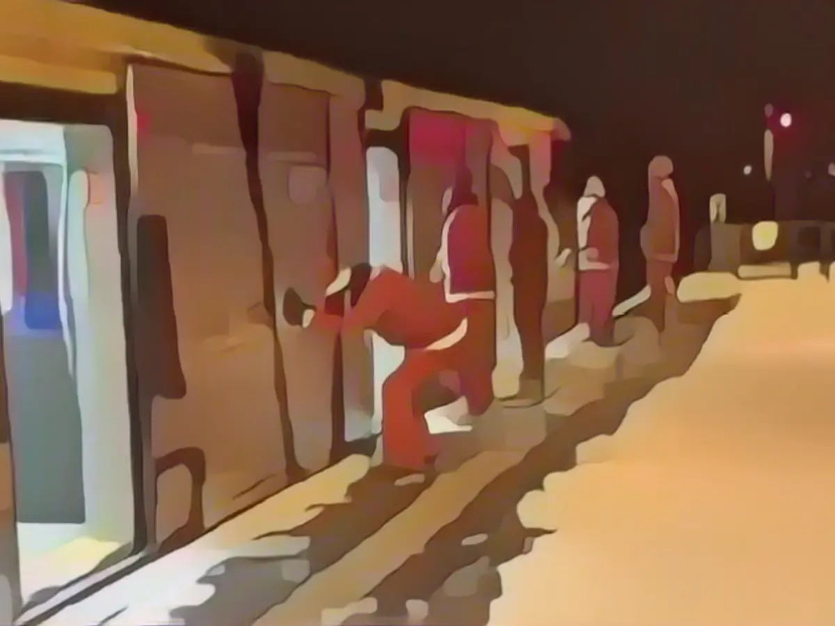 Five Santas spray the suburban train