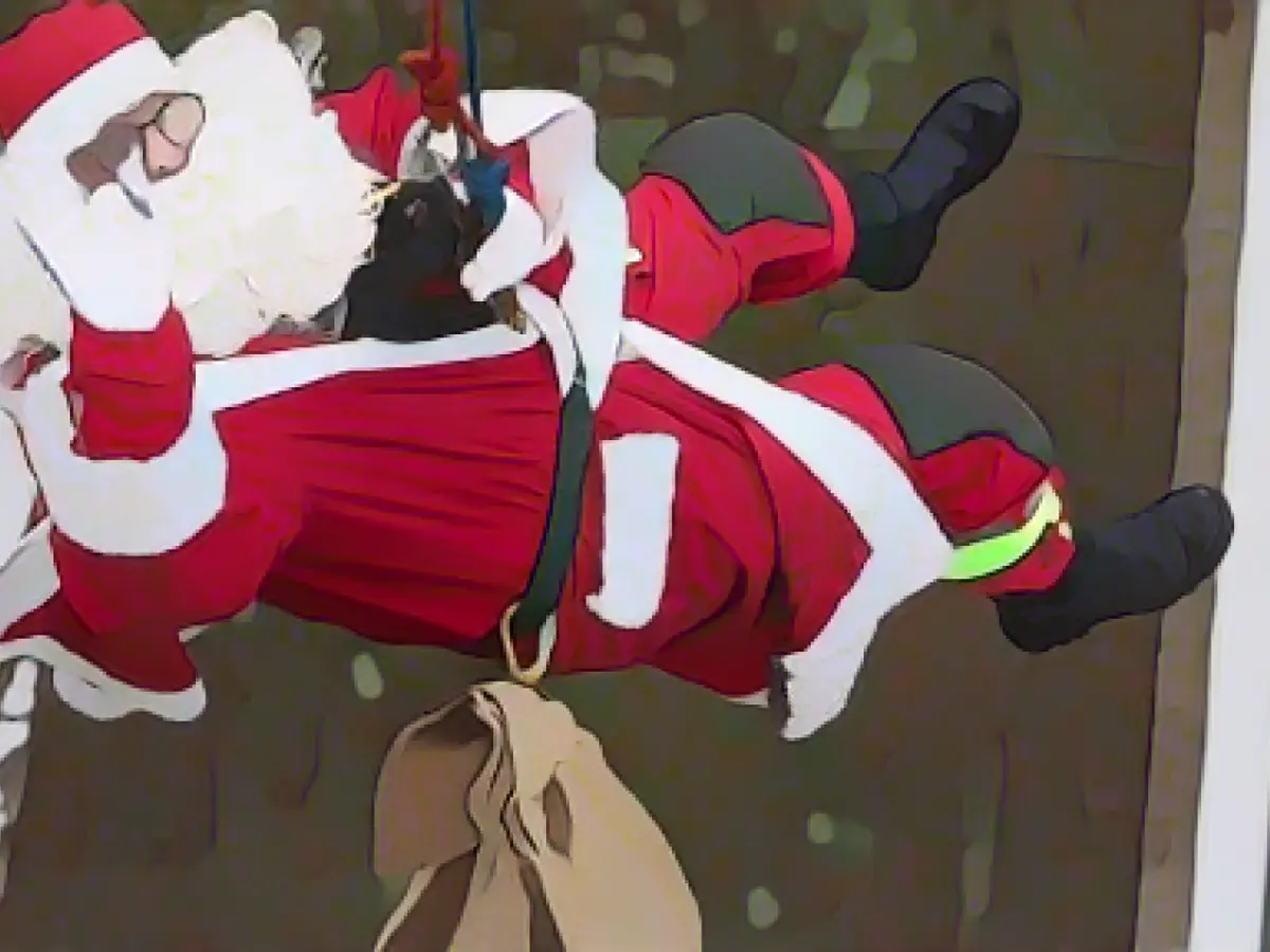 Costumed firefighters give presents to children